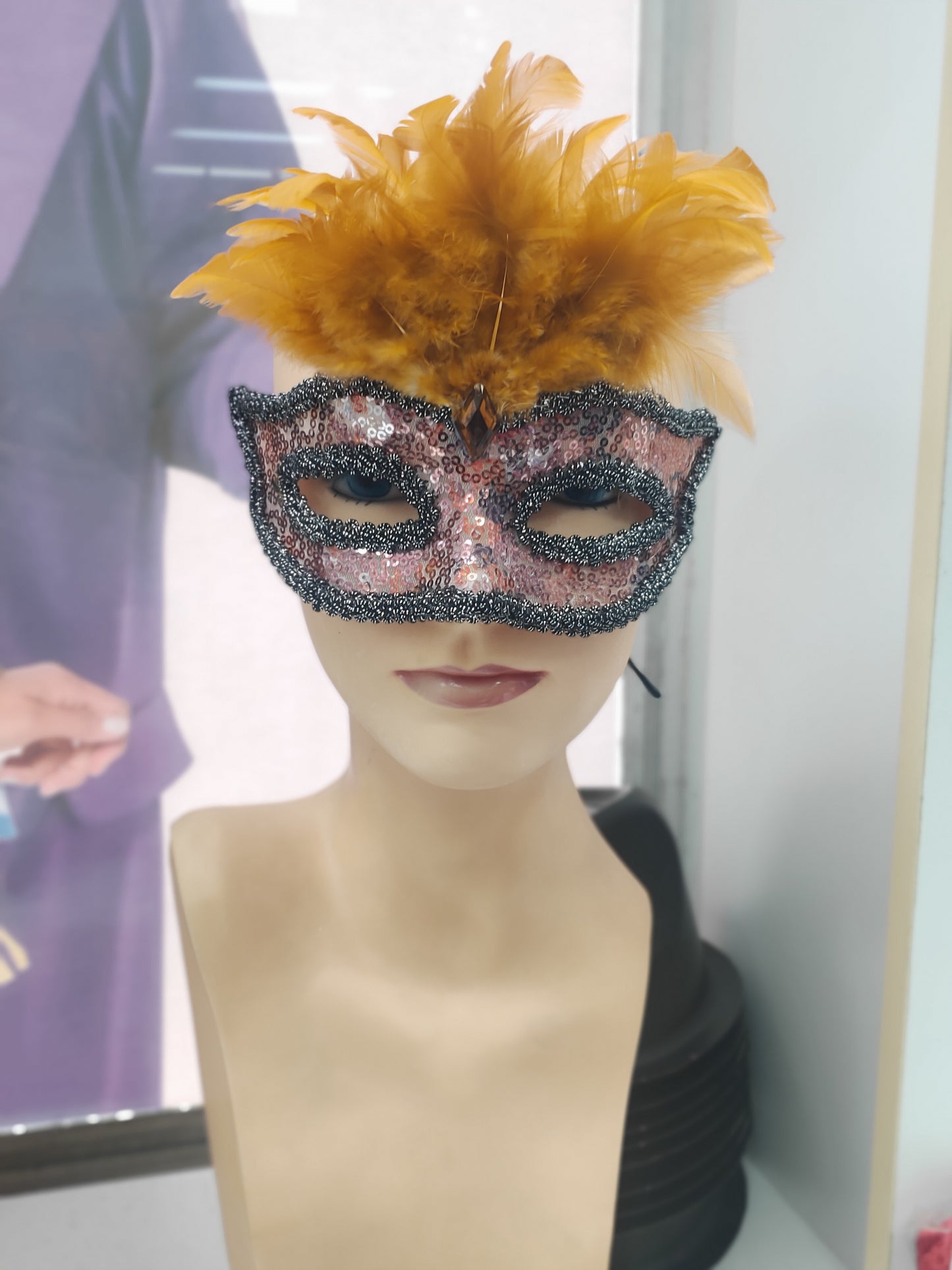 Orange mask with feathers